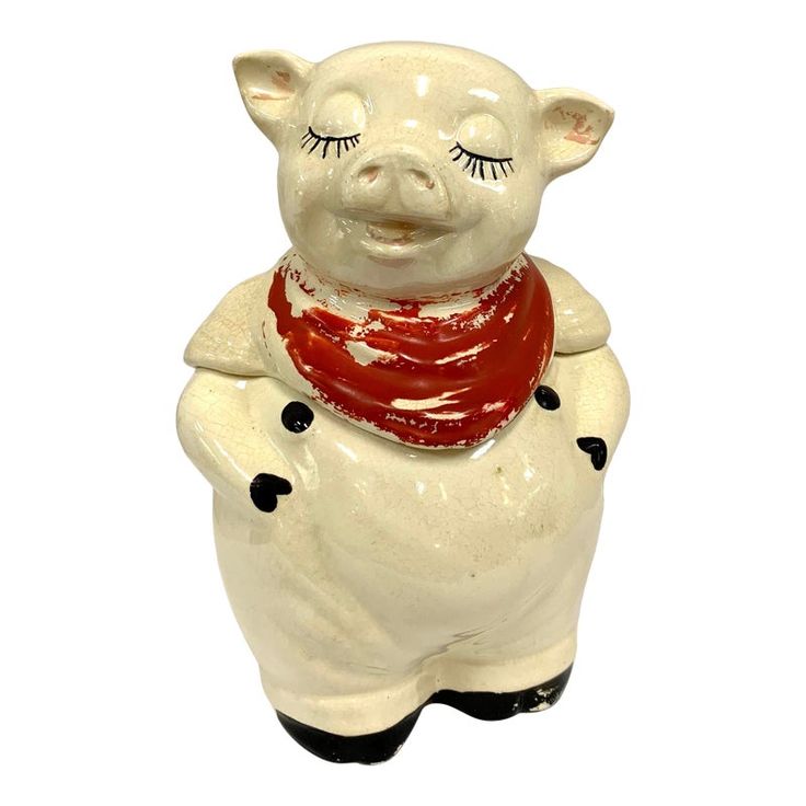 a ceramic pig with a scarf around its neck