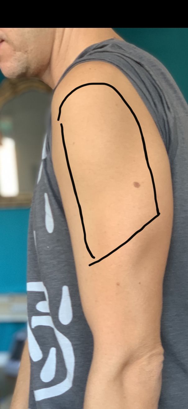 a man with a tattoo on his arm that has a circle drawn in the middle