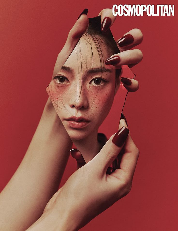 a woman is holding her hair in front of her face with the words cosmopolian on it