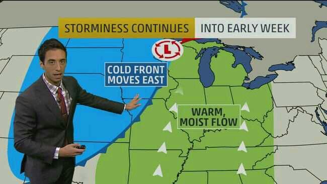 a man in a business suit pointing at a weather map with the words cold front moves east