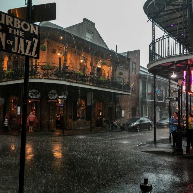 a rainy street scene with people walking in the rain