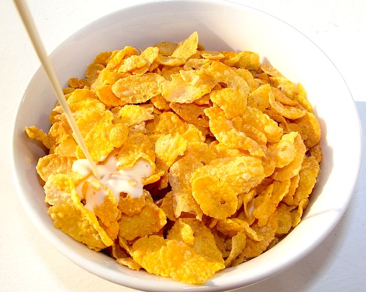 a white bowl filled with corn flakes