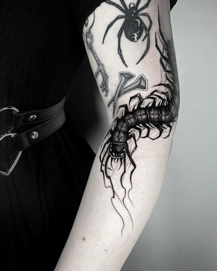 a woman with a spider tattoo on her arm