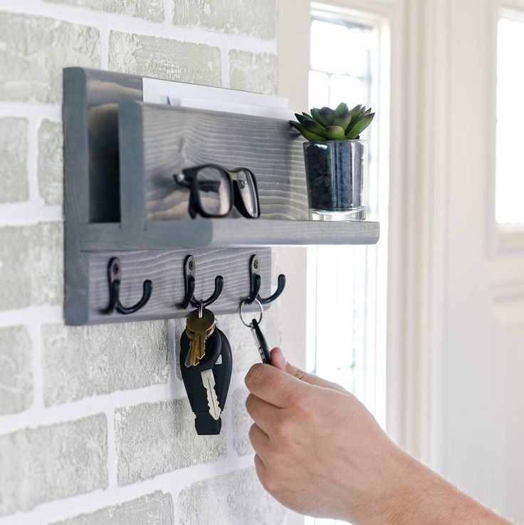 "Keep your home or office organized with this Hanging Mail and Key Shelf. This handcrafted flush mount wall mail organizer is made using solid wood and can be finished to suite your style. Three double prong hooks provide ample storage for your keys, scarves, purse and even dog leashes. While the pocket area in the back of the shelf provides you an area to discreetly store your mail, phone, tablet and other electronics. In front of the mail sorter is a small shelf perfect for your glasses, spare Wall Mail Organizer, Small Wooden Projects, Key Shelf, Key Organiser, Mail Organizer Wall, Workshop Diy, Mail Sorter, Office Shelf, Small Shelf