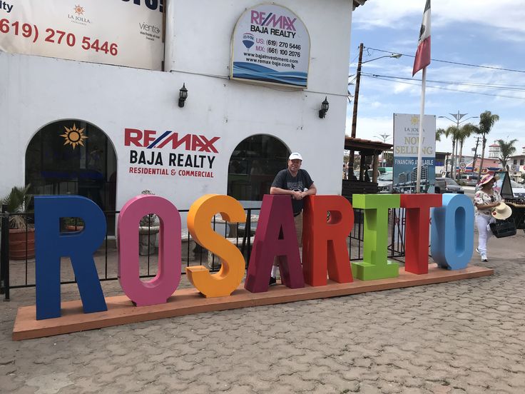 a man standing in front of a sign that says roarteo