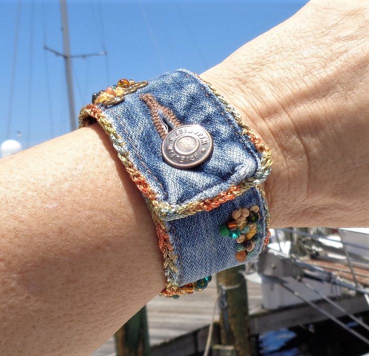 a person's arm with a bracelet made out of jeans