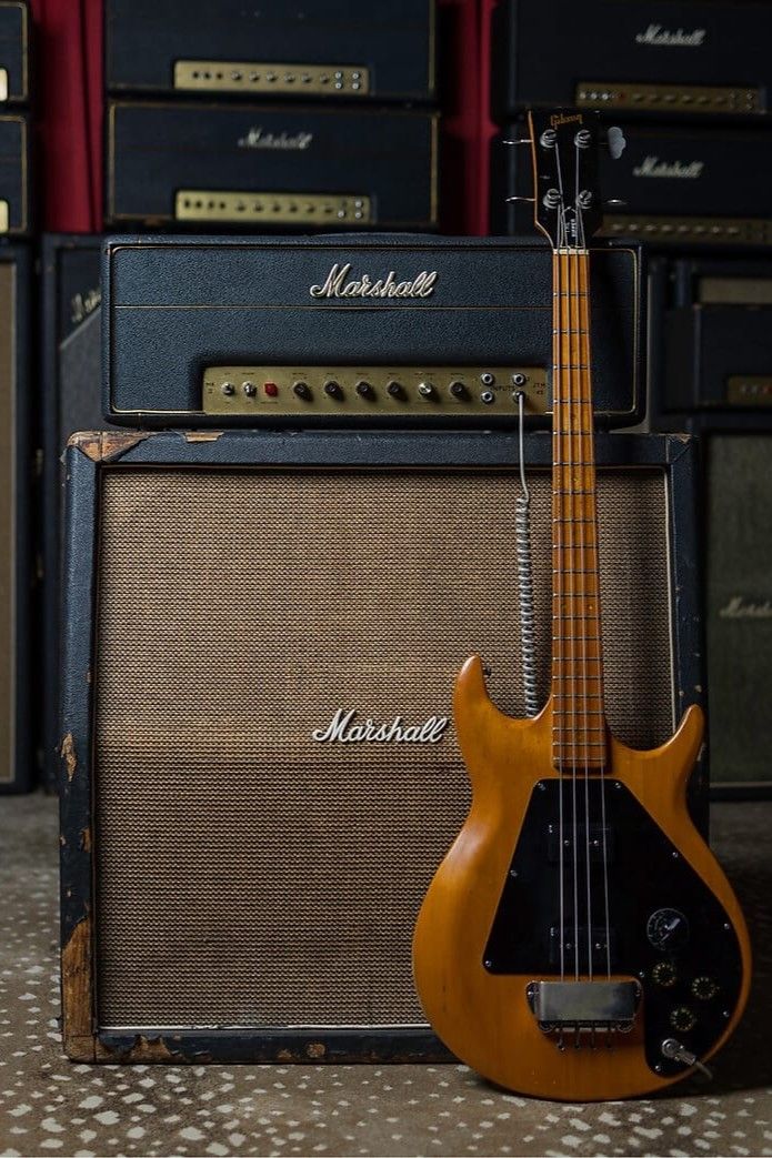 an electric guitar sitting next to some amps