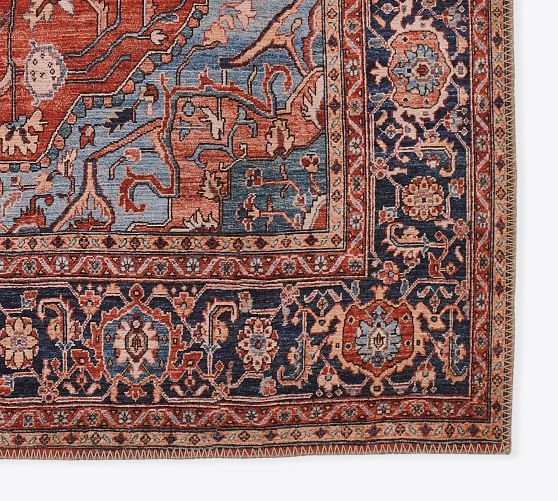 an antique persian rug with blue, red and orange colors on the middle border is shown