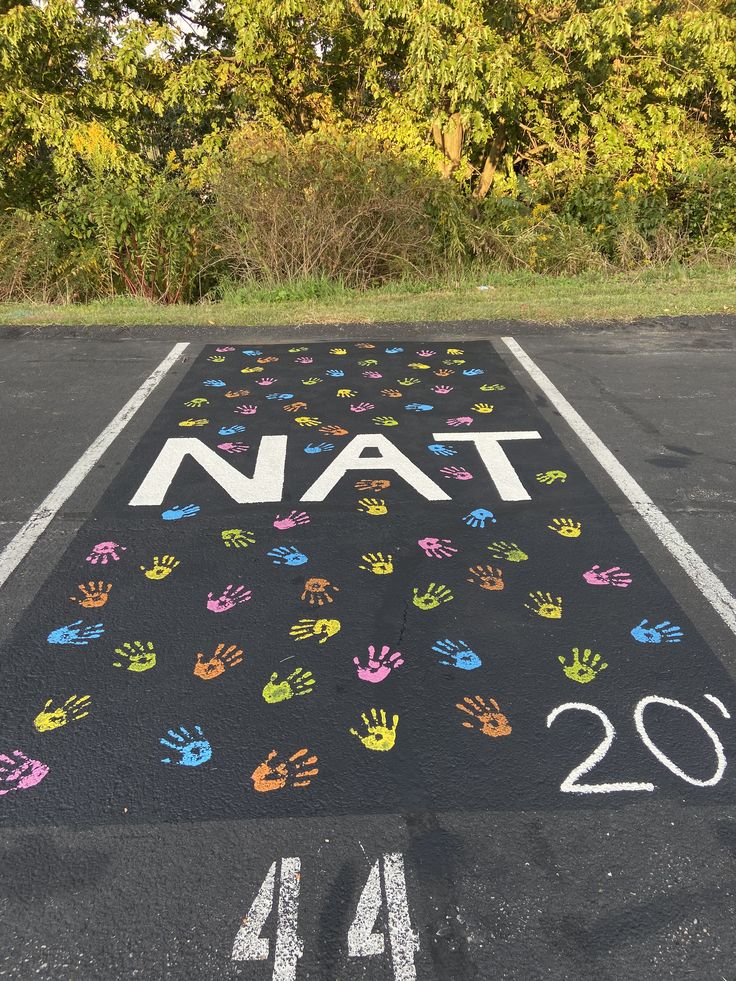 a parking lot painted with hand prints and numbers