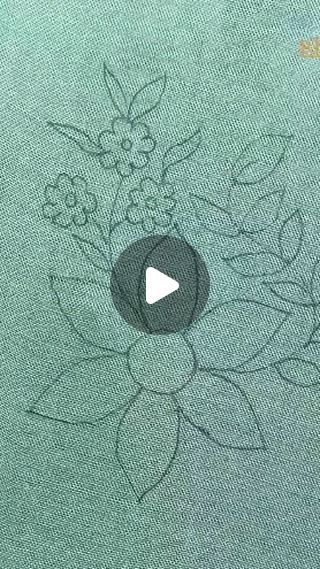 an image of flowers drawn on the back of a t - shirt that is green