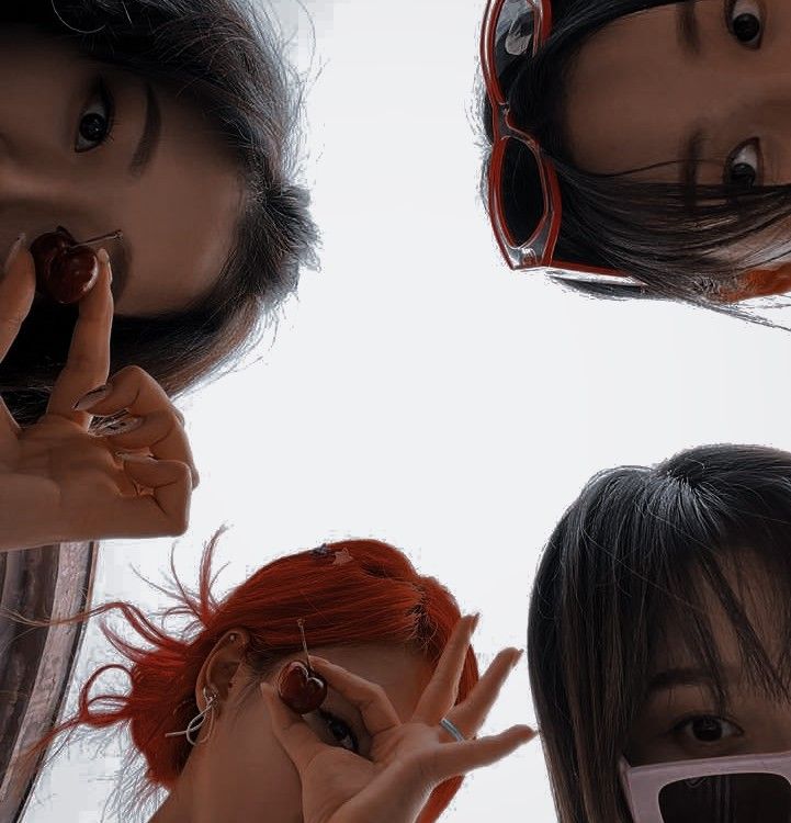 three women with red hair and sunglasses are looking up at the sky while holding their hands together