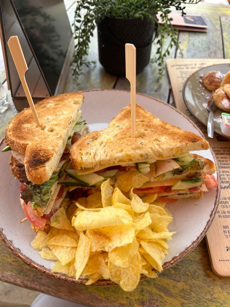 a sandwich and potato chips on a plate