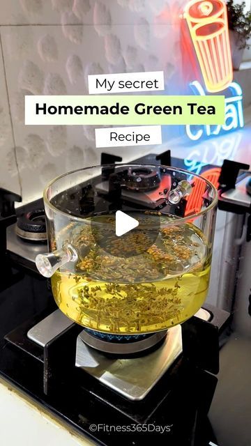 a glass bowl filled with green tea sitting on top of a stove