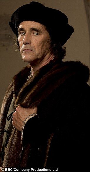 a man in a fur coat and hat looking off into the distance with his hands on his chest