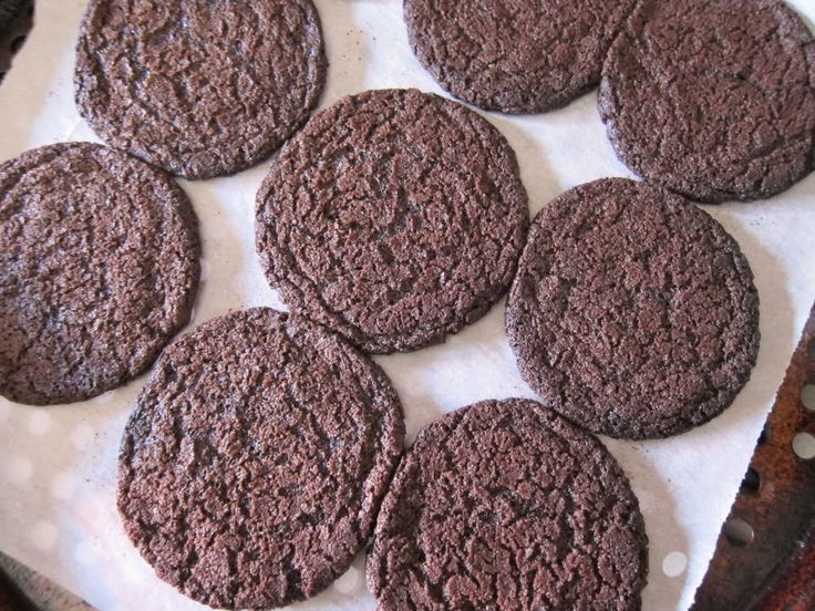 several chocolate cookies sitting on top of a table