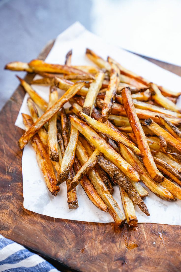 french fries on a cutting board ready to be eaten