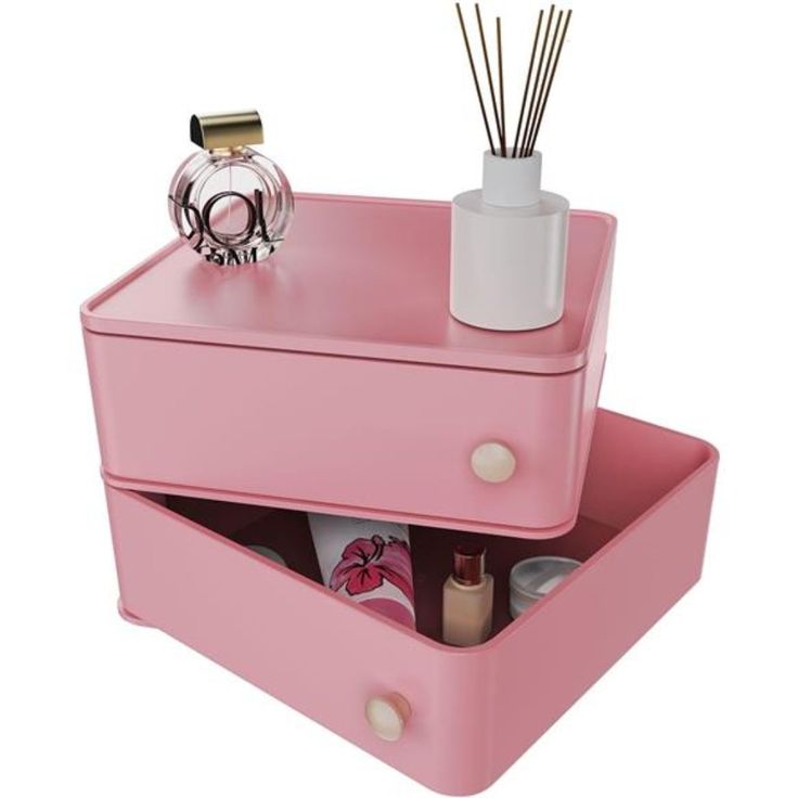 a pink drawer with two drawers and some candles