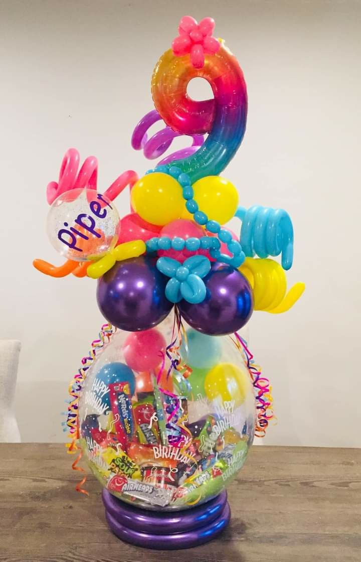 a bunch of balloons that are in a vase on a table with the number 50