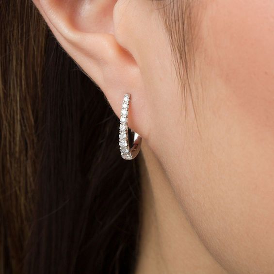 Take your dressy looks to the next level with these dazzling certified diamond hoop earrings. Created in 14K white gold, each 17.0 x 12.0mm oval-shaped hoop features a row of sparkling graduated-size diamonds - the largest being 1/20 ct. stones. Each diamond boasts a color rank of H and a clarity of I1. Radiant with 1/2 ct. t.w. of diamonds and a bright polished shine, these earrings secure with hinged backs. This style arrives with a certificate that includes a photo and description of the diam Zales Jewelry Earrings, Formal Halo Huggie Diamond Earrings, Formal Huggie Diamond Earrings With Halo, Classic Diamond Huggie Earrings With Halo, Oval Diamond Huggie Earrings For Anniversary, Oval Diamond Huggie Earrings Fine Jewelry, Diamond Oval Huggie Earrings Fine Jewelry, Elegant Oval White Gold Huggie Earrings, Elegant Halo Diamond Huggie Earrings