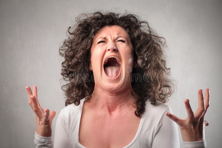 a woman with her mouth wide open and hands in front of her face as if screaming