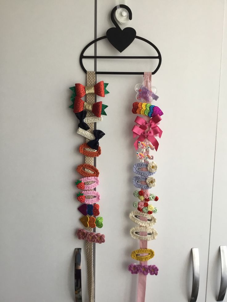 several different types of hair ties hanging on a wall