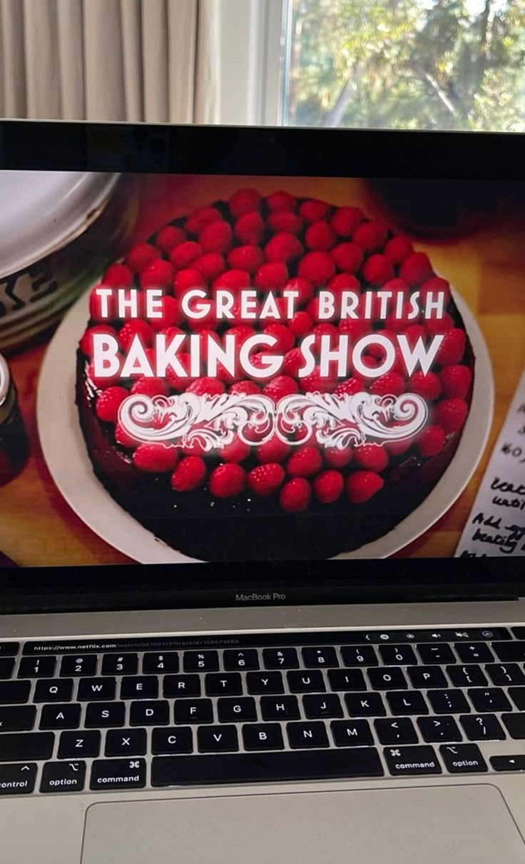 an open laptop computer displaying the great british baking show on it's display screen