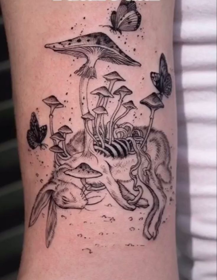 a black and white tattoo with mushrooms on it