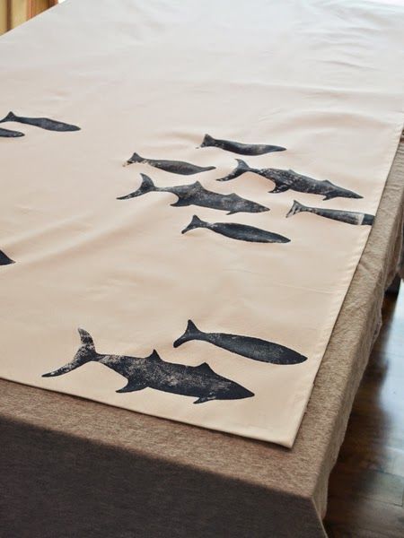 there is a sheet with fish on it that has been made into a tablecloth