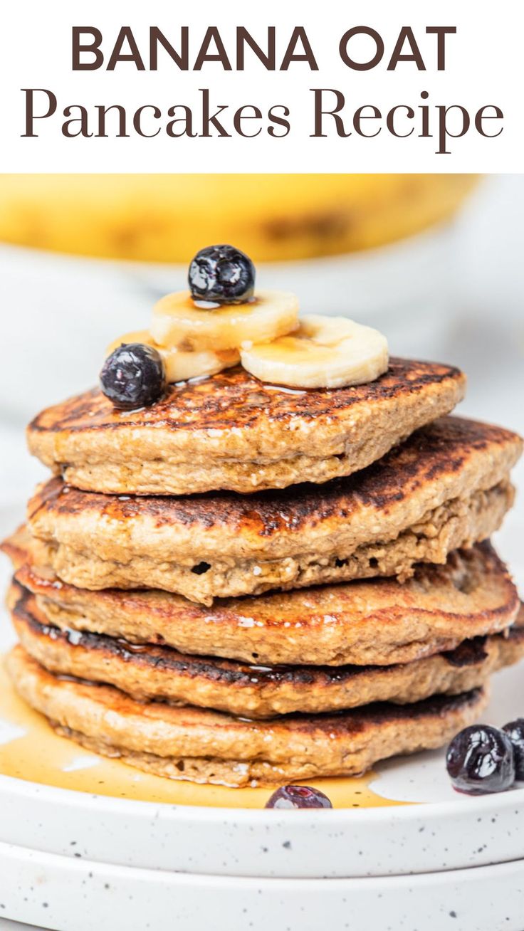 a stack of pancakes with bananas and blueberries on top