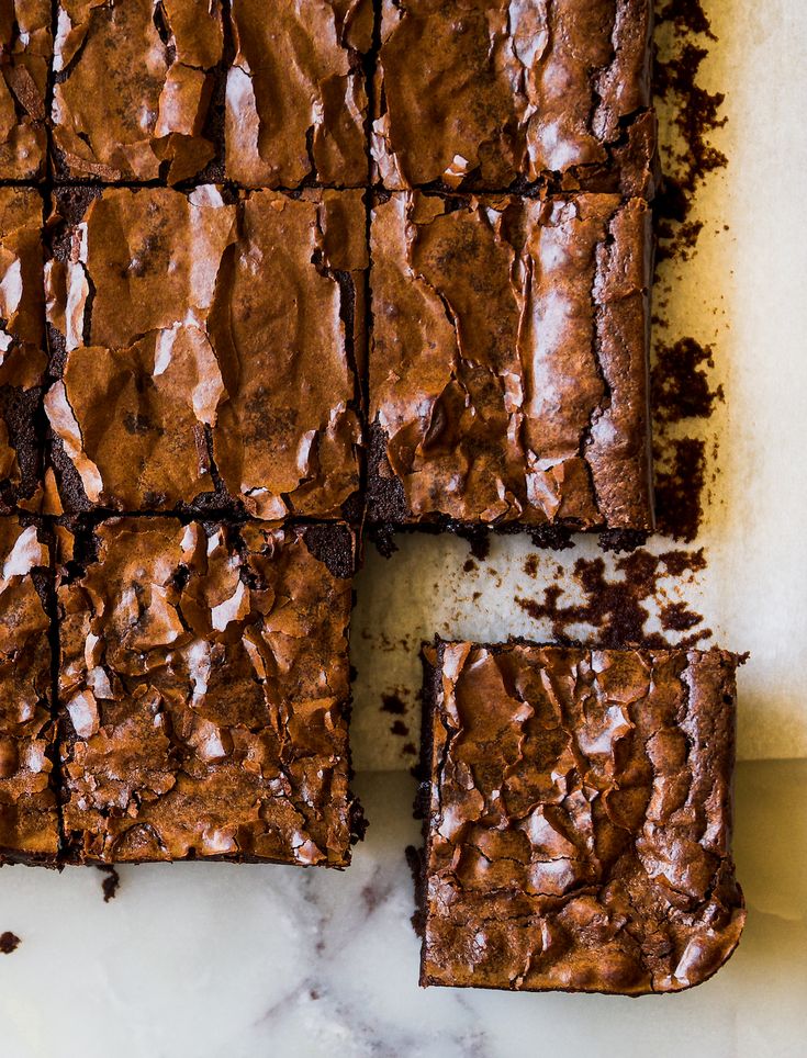 chocolate brownies cut into squares on a white surface