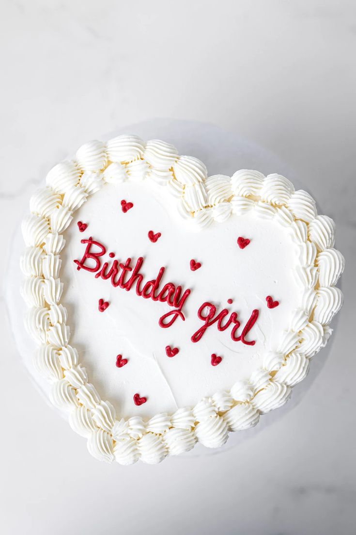 a heart shaped cake with the words birthday girl written on it