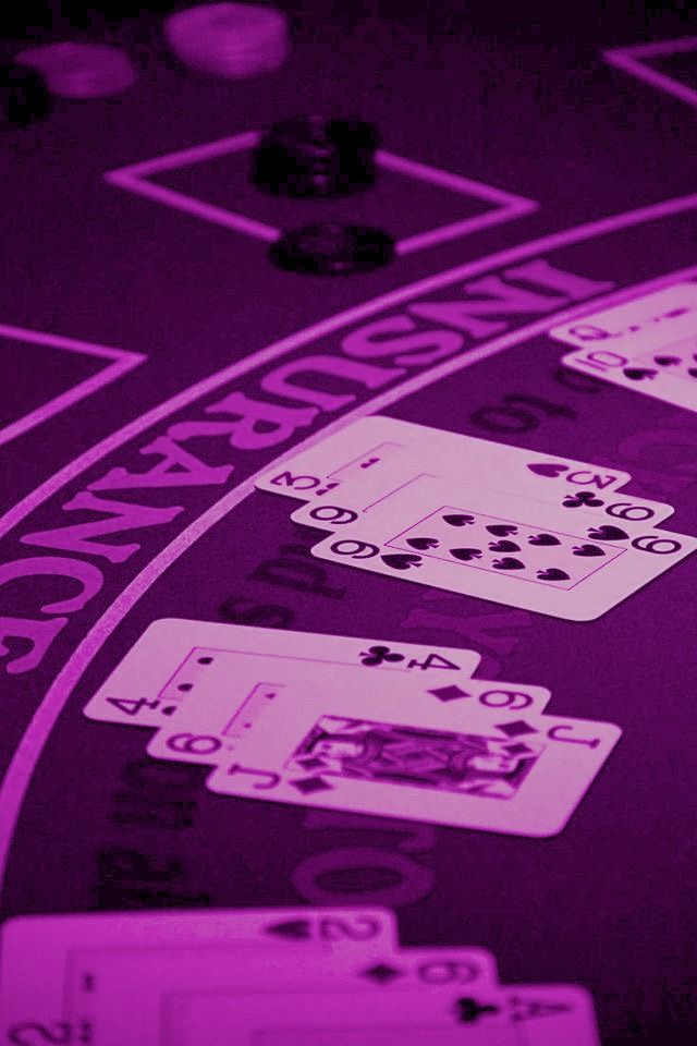 a purple casino table with black and white cards on it's sides, all in the same direction