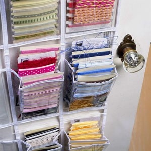 the closet is filled with lots of different types of fabric and sewing supplies in it