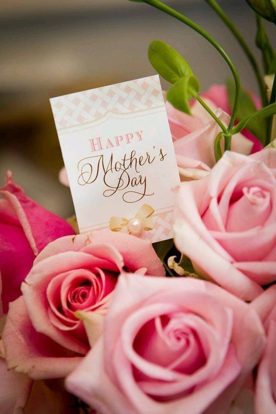 a bouquet of pink roses with a happy mother's day card attached to it