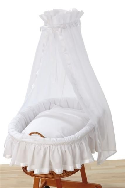 a white crib with a canopy over it's head and footrests