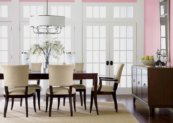 a dining room table with chairs and a chandelier