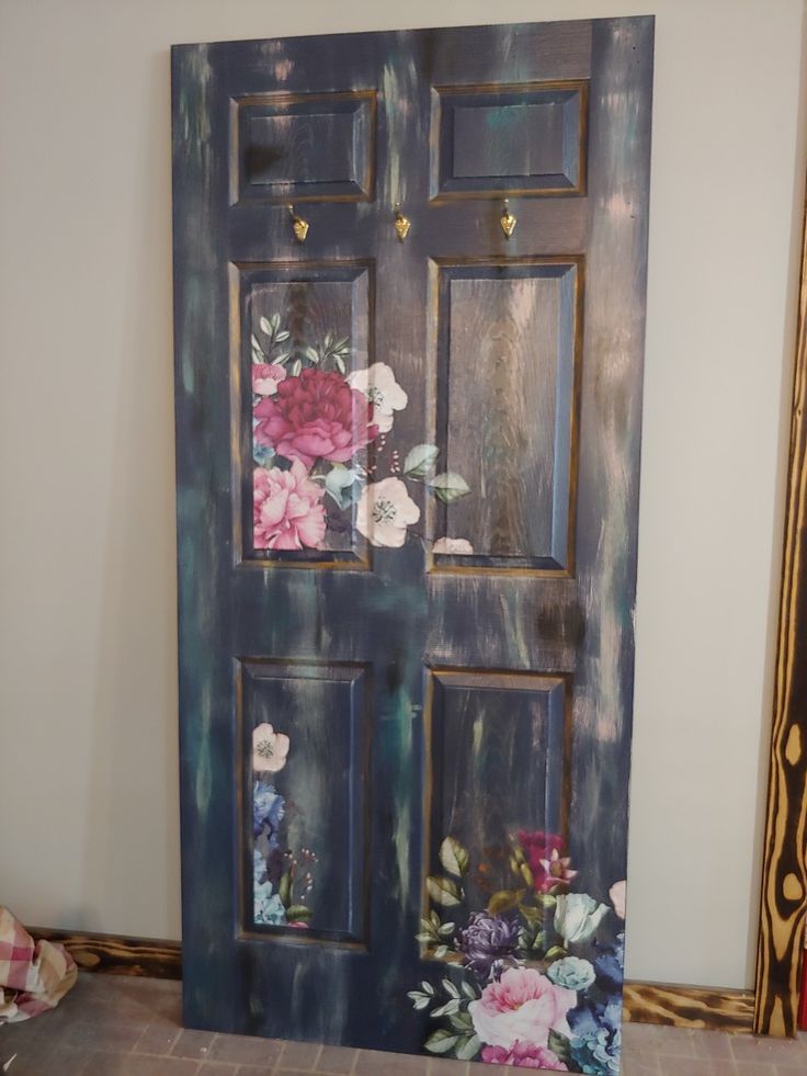 an old door with flowers painted on it