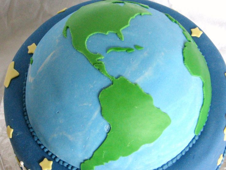 a blue and green cake with the earth on it