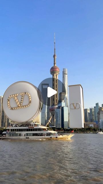 a boat traveling down the river in front of tall buildings