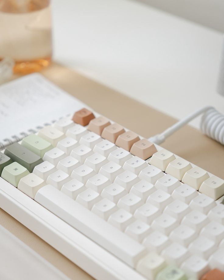 a computer keyboard sitting on top of a desk