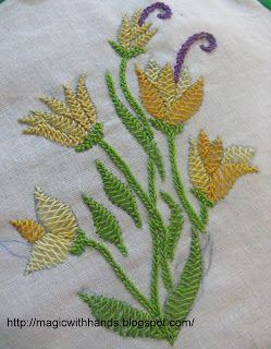 a close up of a white cloth with flowers embroidered on the front and back of it