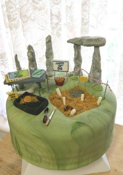 a table that has some kind of fake rock formation on it with other items around it