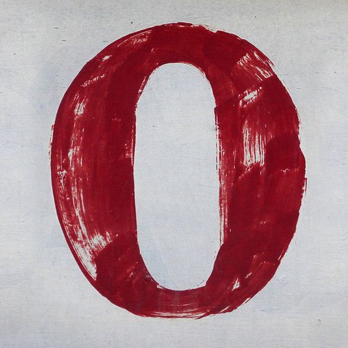 the letter o is drawn in red on white paper