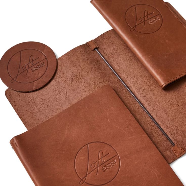 two brown leather notebooks with matching coasters