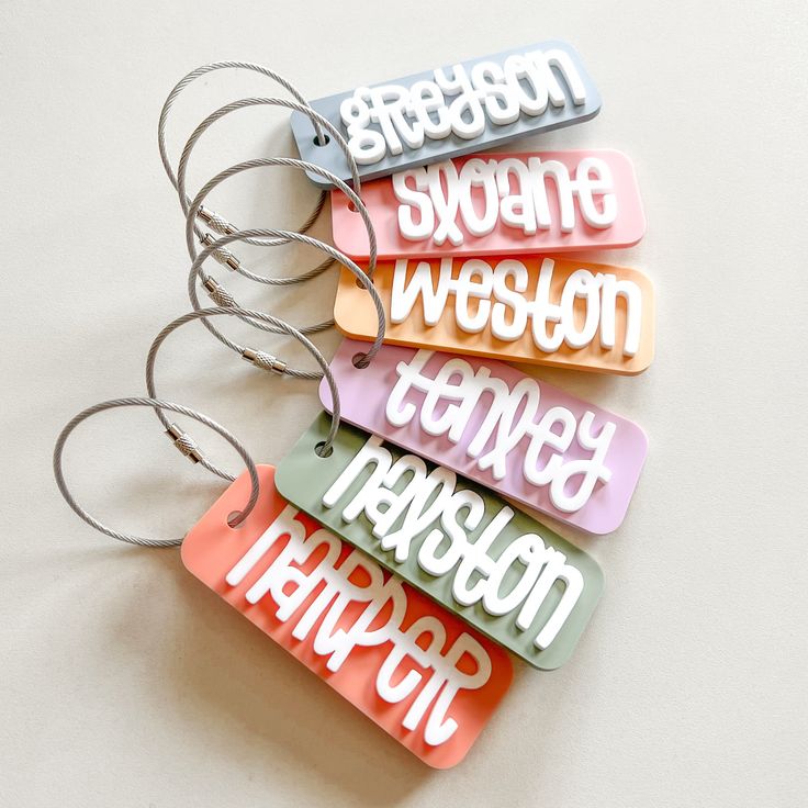 Kids Backpack or Lunchbox Tag : . : . : ITEM DETAILS : . : . : Tag is approx. 3.5" wide. Name will be in white acrylic in the font shown. Select one color for the background of the tag. In the personalization box, please leave the name you would like on the tag. Comes with a cable wire keyring.  Laser cut from acrylic. IMPORTANT: These bag tags are made from acrylic, which is a hard plastic. Please handle with care. If dropped or banged against a hard surface, they most likely will break. We are Shrink Plastic Name Tags, Cricut Bag Tag Baby, Cricut Tags Bags Boxes And More, Kids Backpack Tags, Kids Bag Tags, Acrylic Projects, Acrylic Tags, 2025 Ideas, Keychain Acrylic