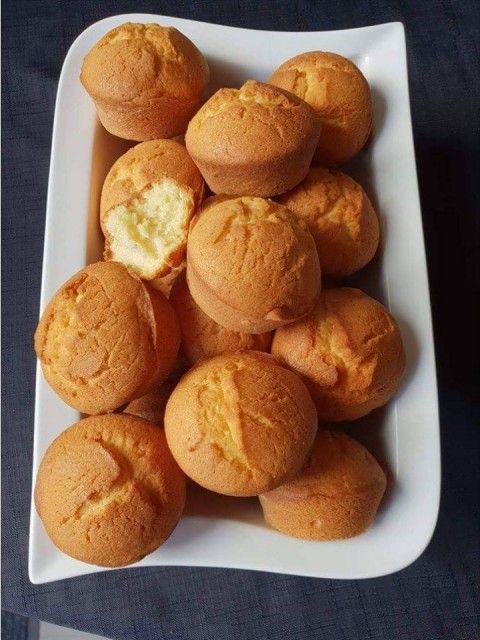 some muffins are sitting on a white plate