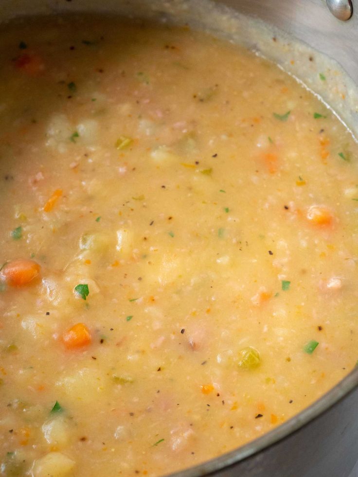 a pot filled with soup sitting on top of a stove