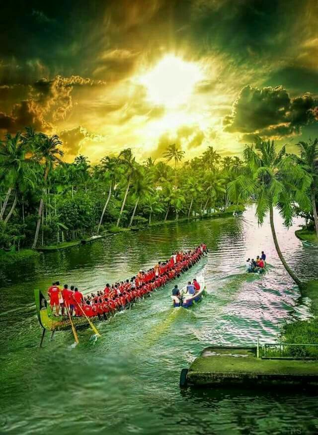 a long boat filled with people riding down a river