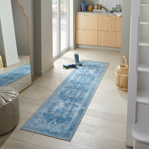 a blue runner rug in the middle of a living room