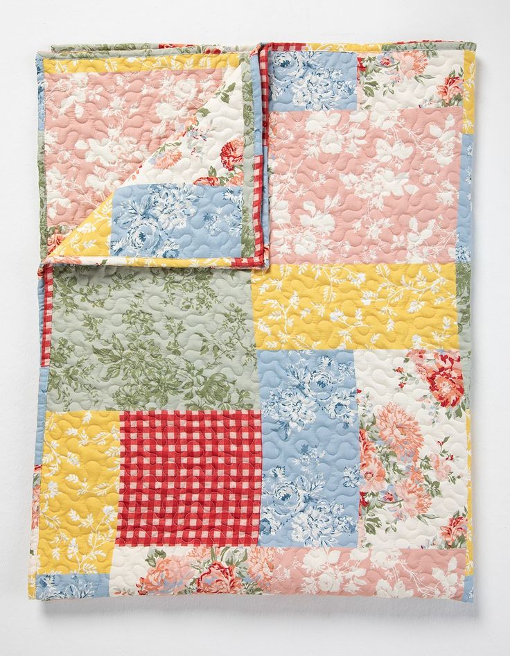 a patchwork quilt with flowers on it